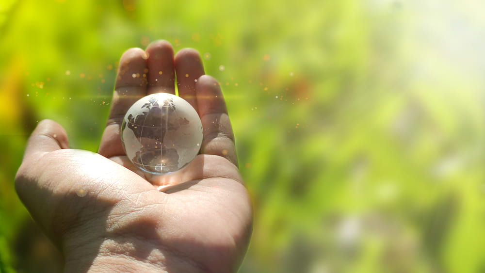 A glass world in a person's hand.