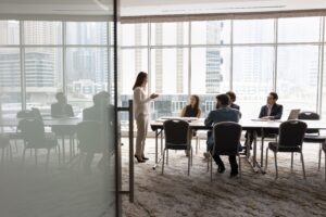 Wide Shot Of Multiethnic Business Team Talking At Meeting Table